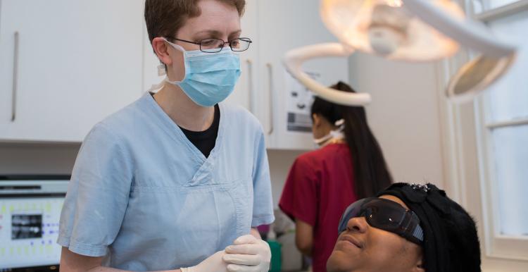 Dentist with patient in dentist chair