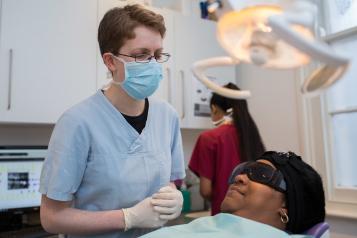 Dentist with patient in dentist chair