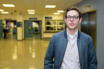 Young man in hospital foyer